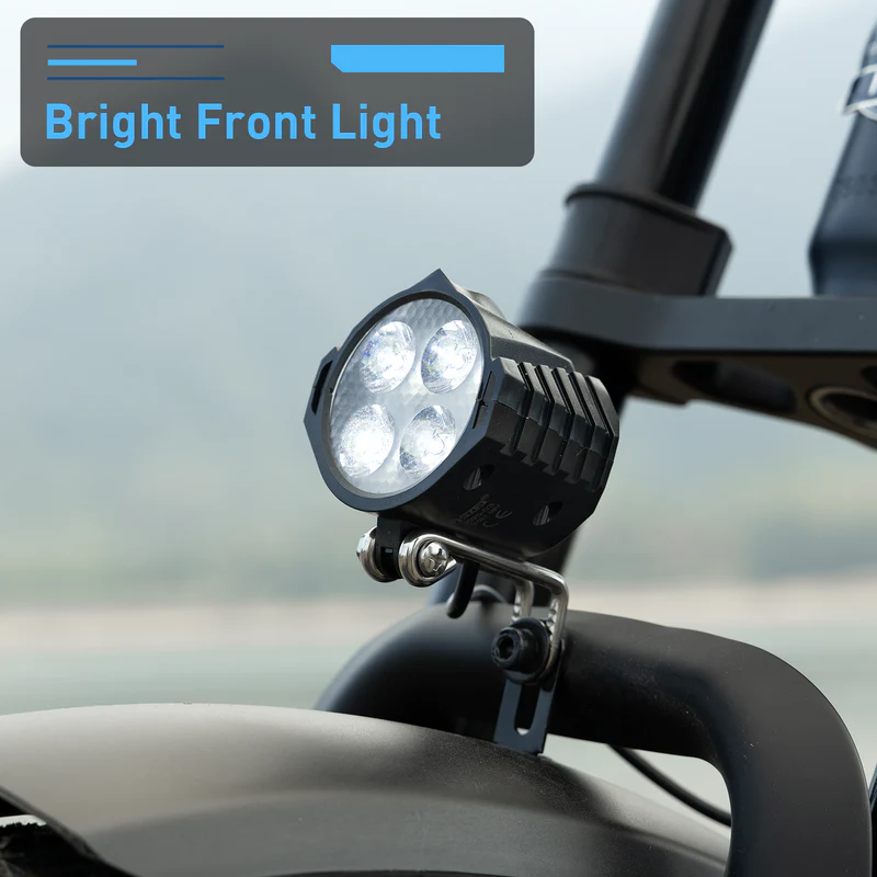 Close-up of the Hiboy - EX11’s front light with four LEDs, mounted on the handlebars of this 750W motor electric bike from Hiboy. A label in the background reads "Bright Front Light.