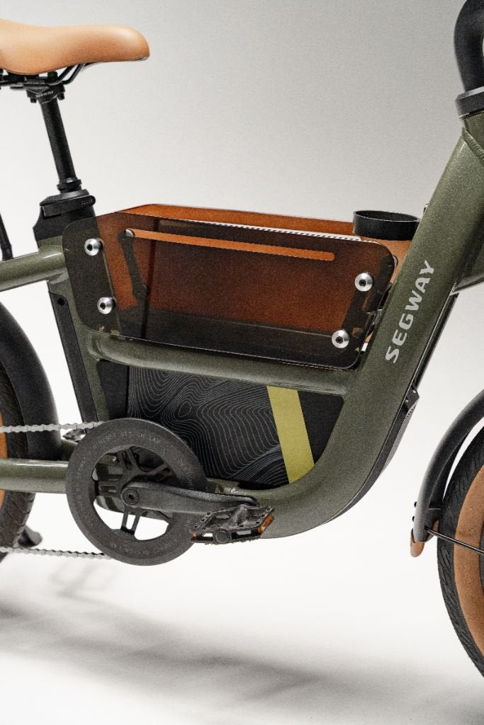 Close-up of the Segway Muxi by Segway, highlighting its sturdy frame, pedals, and a clear side battery compartment featured on this powerful 750W electric utility bike.