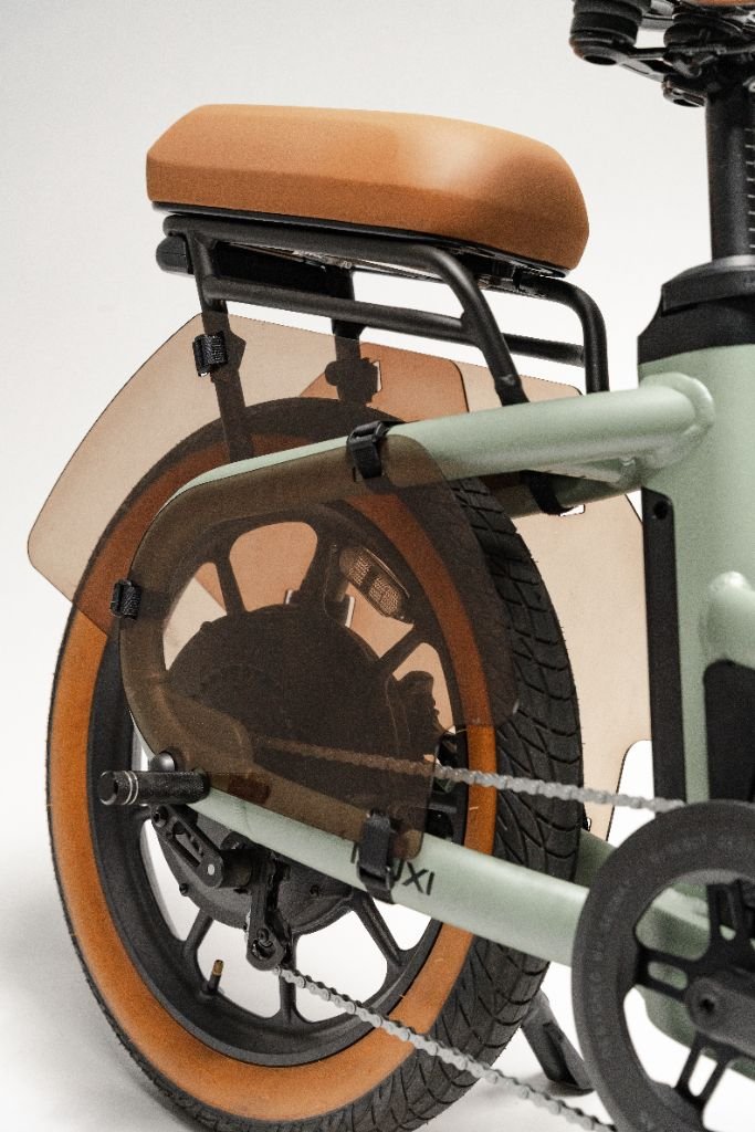 Close-up of the Segway Muxi’s rear wheel, highlighting its tan seat, matching tan tire sidewall, and a translucent brown fender.