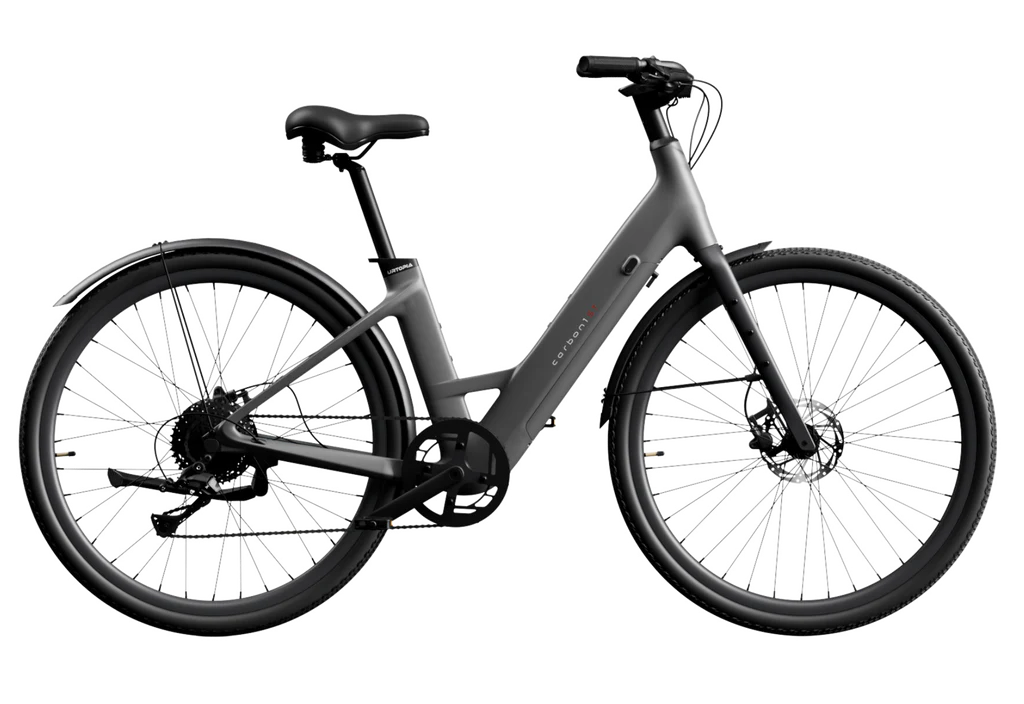 The Urtopia - Carbon 1 Step-Thru by Urtopia is a matte black electric step-thru bike featuring fenders, front and rear disc brakes, and a rear hub motor—lightweight, stylish, and convenient, shown from the side on a white background.