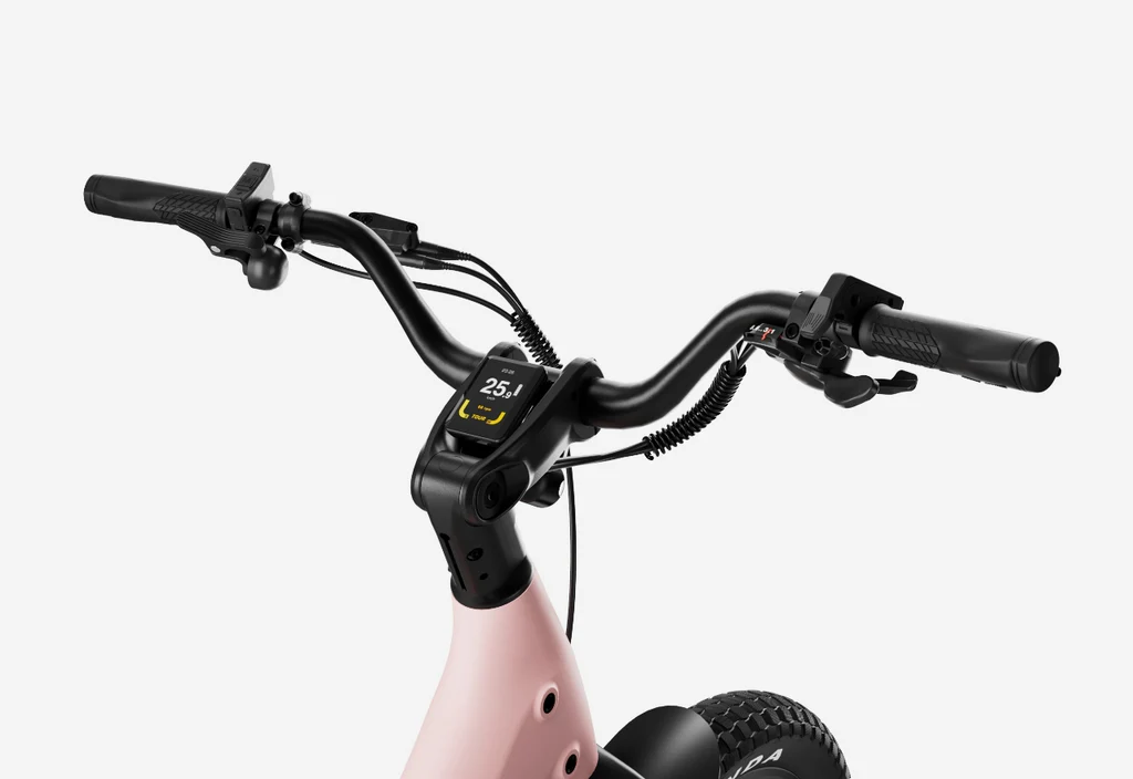 Close-up of the Urtopia - Carbon Joy Ultra carbon fiber e-bike handlebar with a digital display showing 25.1 km/h, mounted on a light pink frame by Urtopia.