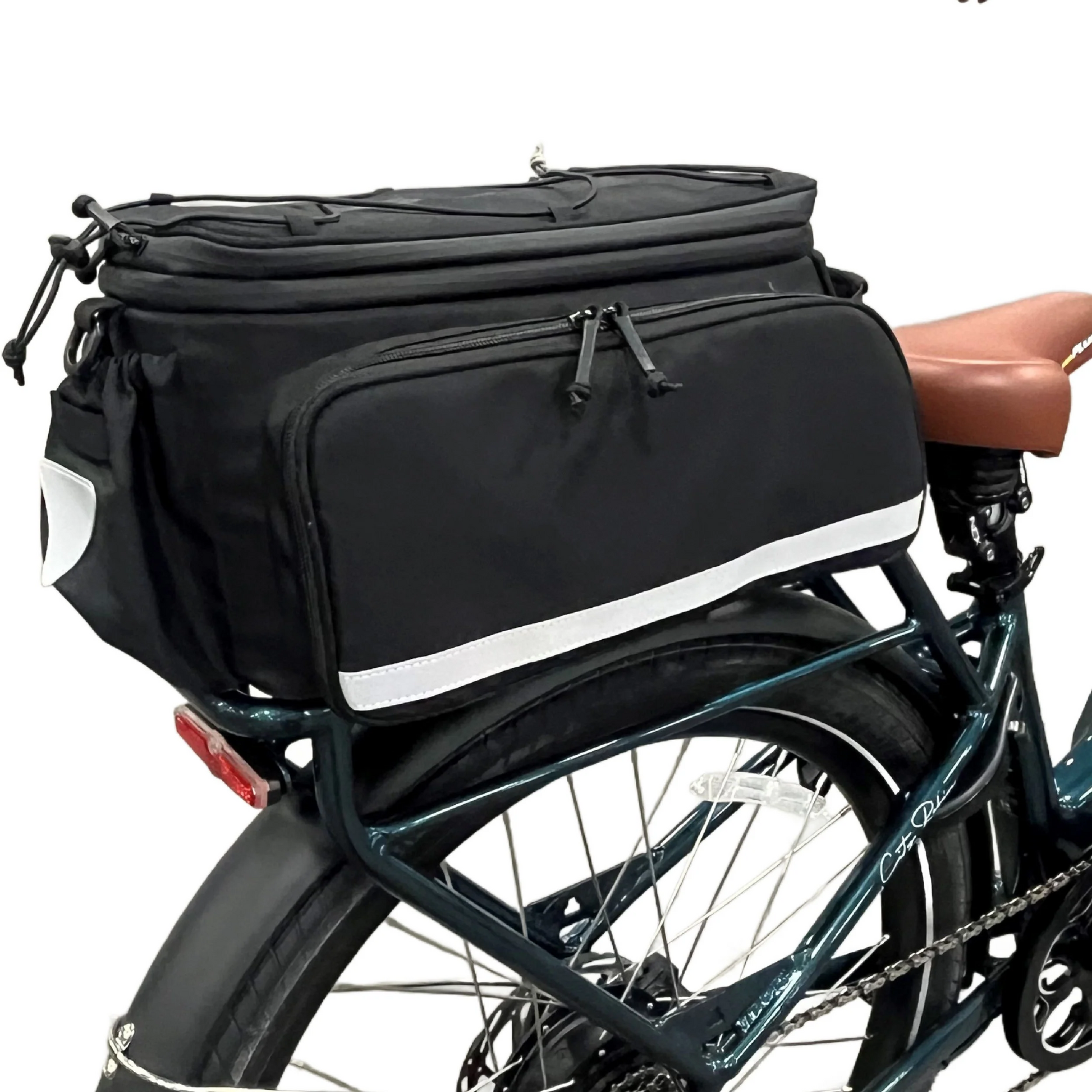 The Bikase Big Poppa MIK bag securely attaches to a rear bike rack, featuring multiple compartments with waterproof zipper closures and reflective strips. It also includes expandable panniers for extra space, and a brown bike saddle can be seen partially underneath.