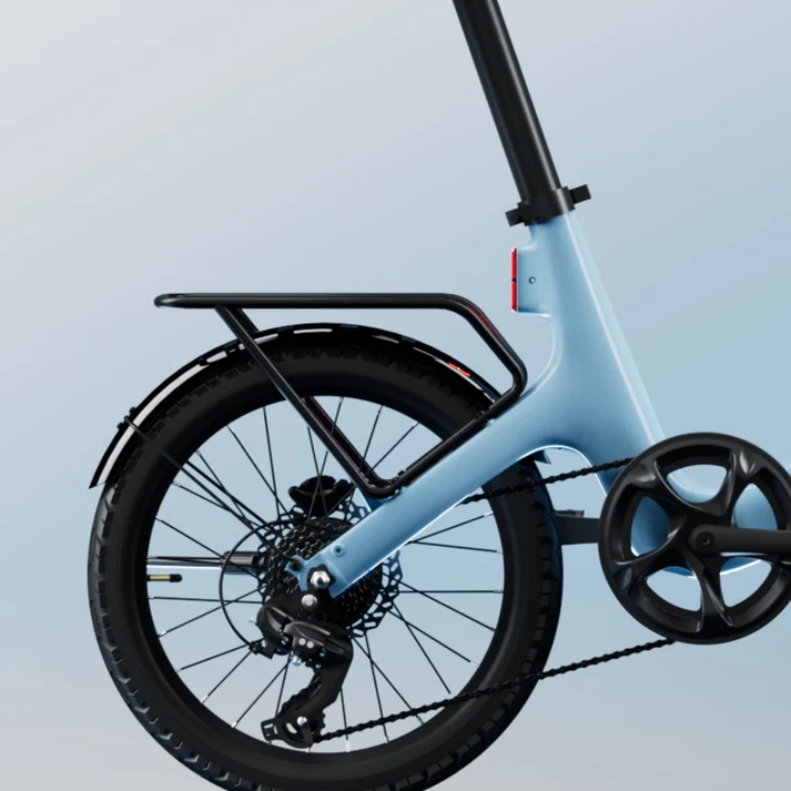 Close-up of the Urtopia Rear Rack on the Fold ST electric folding bike, highlighting its sleek black tire, derailleur, and partial pedal system against a neutral backdrop.
