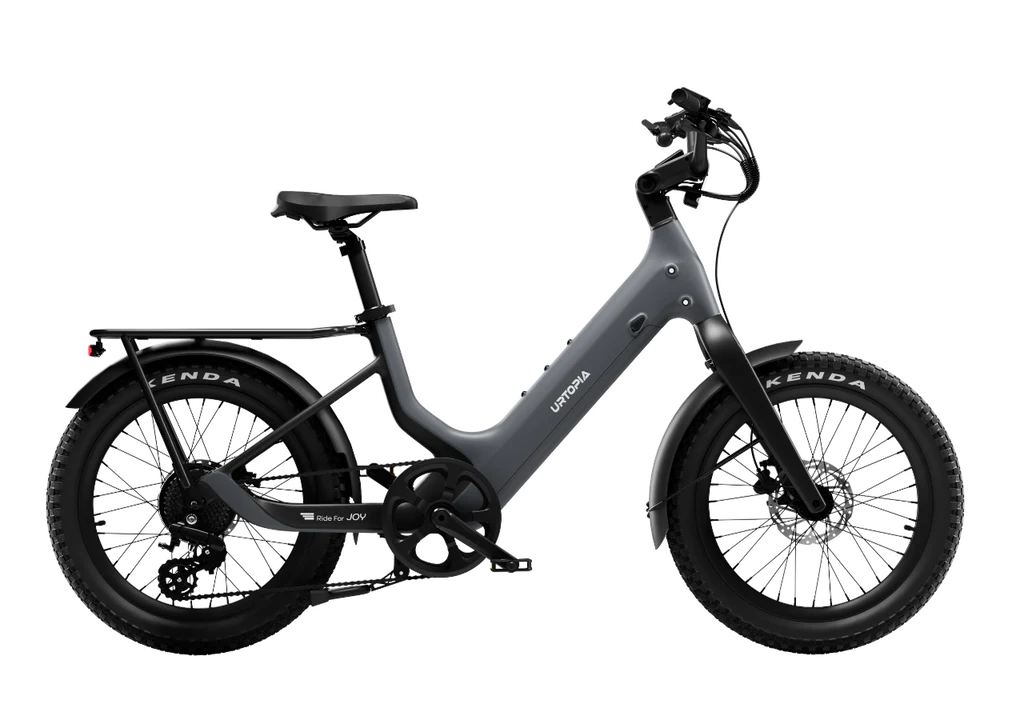 The Urtopia Carbon Joy Ultra by Urtopia, a matte black electric cruiser with thick tires, rear rack, and step-through frame, is shown against a plain white background.