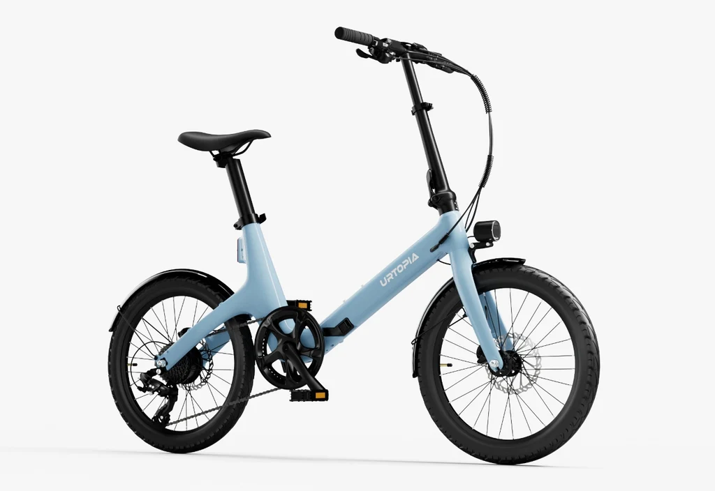 The Urtopia Carbon Fold Step-Thru, a light blue compact e-bike by Urtopia with black wheels, fenders, pedals, and handlebars, is shown from the side against a white background.