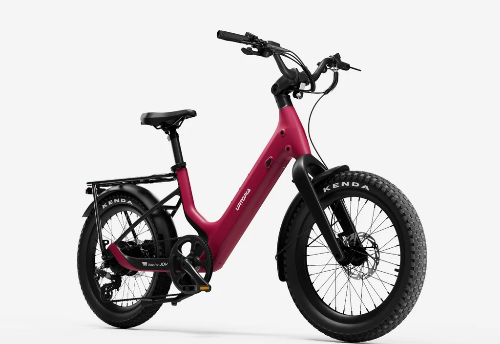 The Urtopia Carbon Joy Ultra electric cruiser bike in red features thick Kenda tires, a step-through frame, rear rack, and sleek styling—presented against a plain white background.
