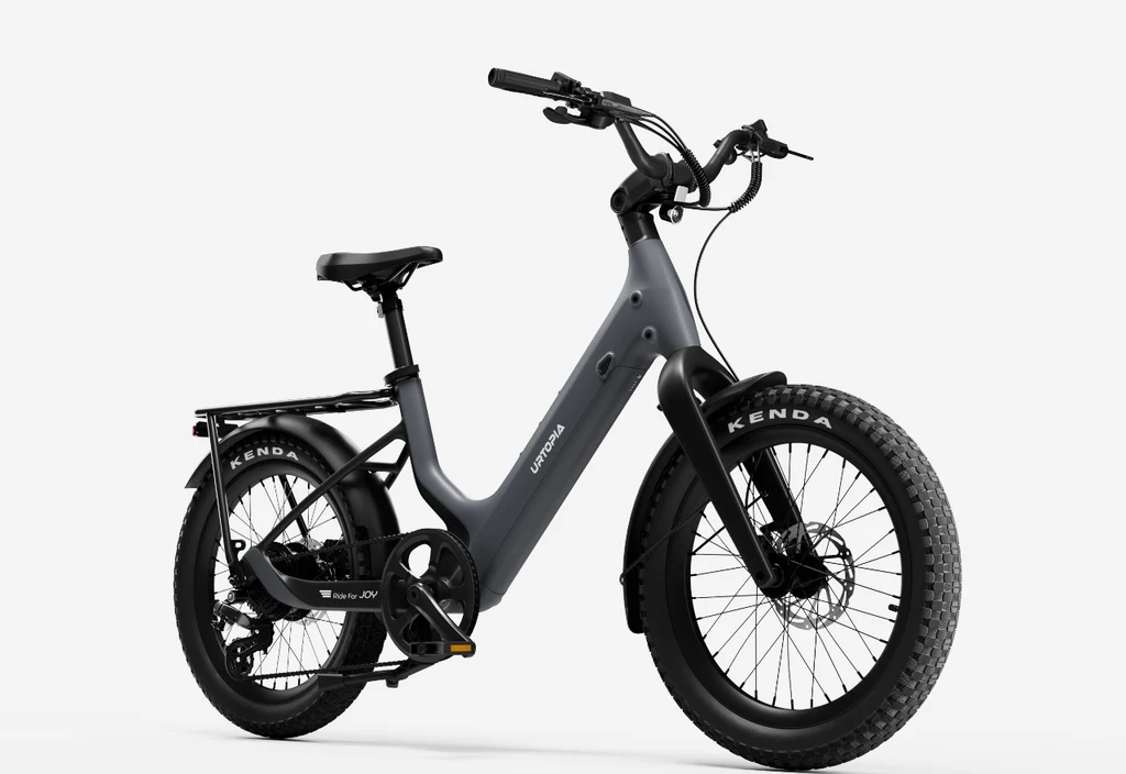 The Urtopia - Carbon Joy Ultra by Urtopia, featuring a matte black step-through frame, thick tires, rear rack, front and rear fenders, is shown against a plain white background.