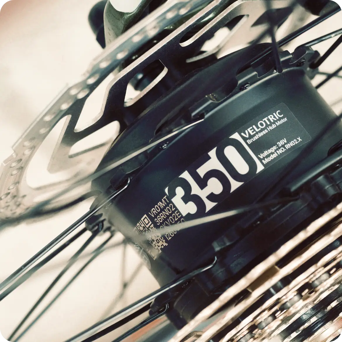 Close-up of the Velotric Tempo’s 350W brushless hub motor, disc brake rotor, gear system, and advanced torque-sensing tech—showcasing this lightweight city eBike by Velotric.