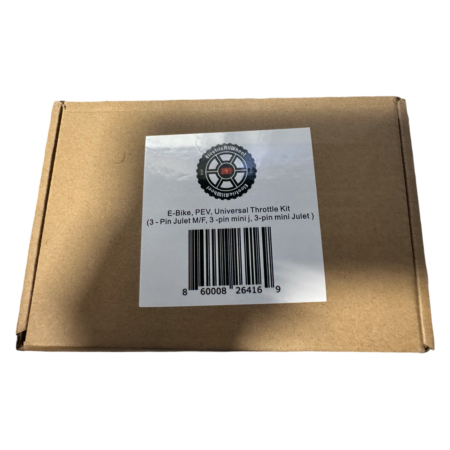 Brown cardboard box with a white label reading "Universal Throttle Harness Kit - E-Bike, PEV (3-Pin Julet M/F, 3-pin mini j, 3-pin mini Julet)" by ElectricAllWheel, plus barcode and circular logo. Ideal for e-bike throttle upgrades or replacement.