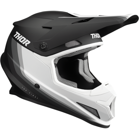 The Thor Sector Helmet - Runner MIPS in black/white features a visor and "THOR" branding on both sides, combining stylish design with advanced safety for motocross riders.