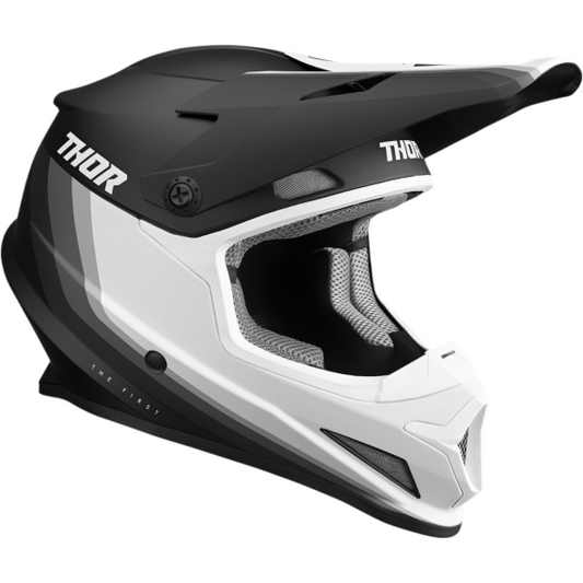 The Thor Sector Helmet - Runner MIPS in black/white features a visor and "THOR" branding on both sides, combining stylish design with advanced safety for motocross riders.