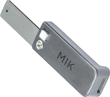 A foldable metal Basil MIK Stick for MIK Adapter Plate with a retractable blade and the letters "MIK" engraved on the handle, making it a handy tool for various tasks.