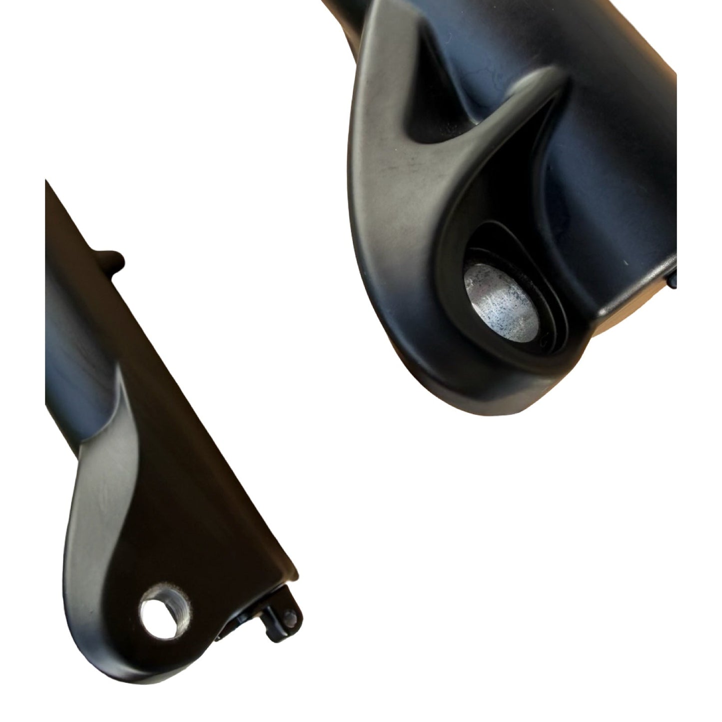 Close-up of two black components with holes and curves, from the ElectricAllWheel RST Guide Dual Crown Fork (26” Fat Tire) + Motorcycle Style LED Headlight Kit (12V, 2-pin Julet)—ideal for upgrading fat tire e-bikes or dual crown fork builds.