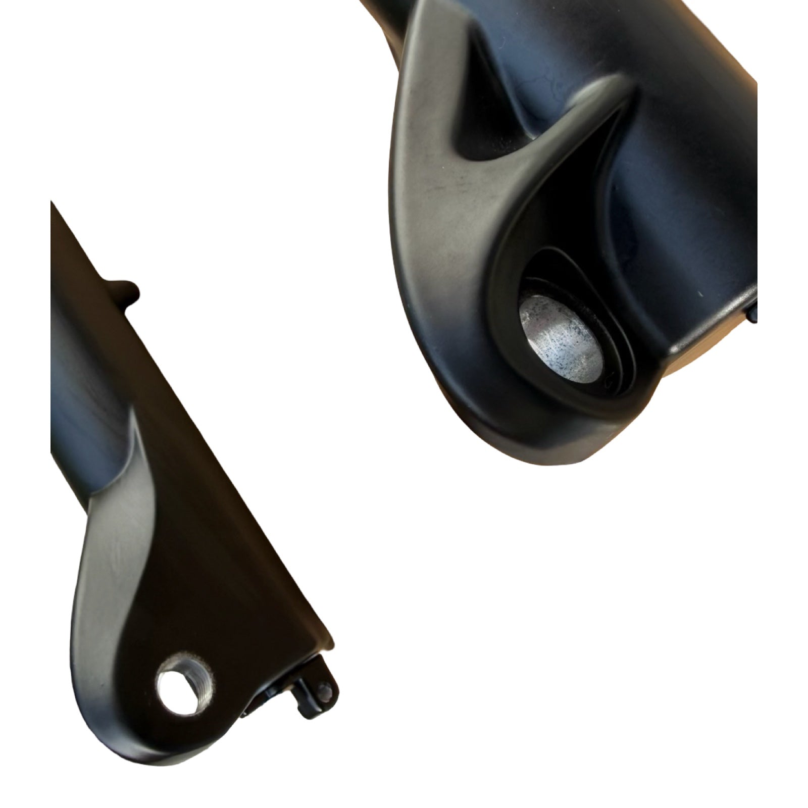 Close-up of two black components with holes and curves, from the ElectricAllWheel RST Guide Dual Crown Fork (26” Fat Tire) + Motorcycle Style LED Headlight Kit (12V, 2-pin Julet)—ideal for upgrading fat tire e-bikes or dual crown fork builds.
