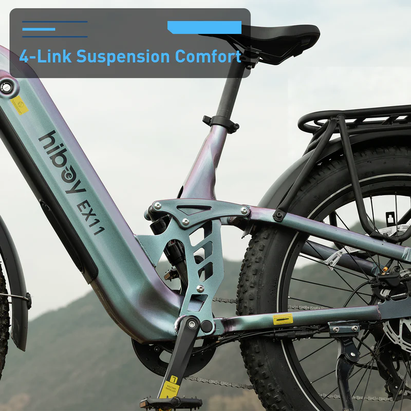 Close-up of the Hiboy - EX11 electric bike frame by Hiboy, highlighting its 4-link suspension system with a partial view of the rear wheel and rack set outdoors.