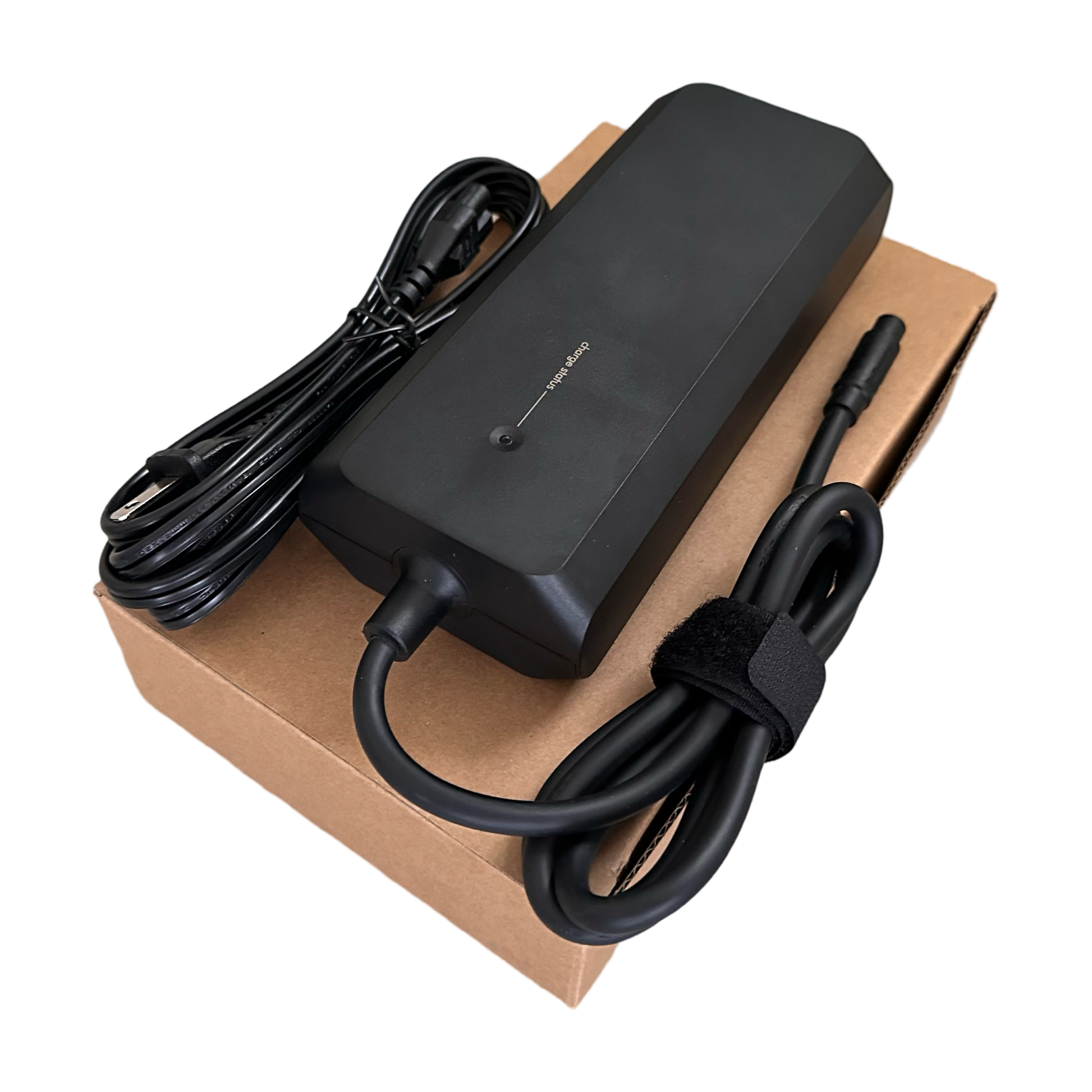 The ElectricAllWheel 52V E-Bike Battery Charger ST3 3A (Ariel Rider Fit) with attached cables sits on a closed brown cardboard box.