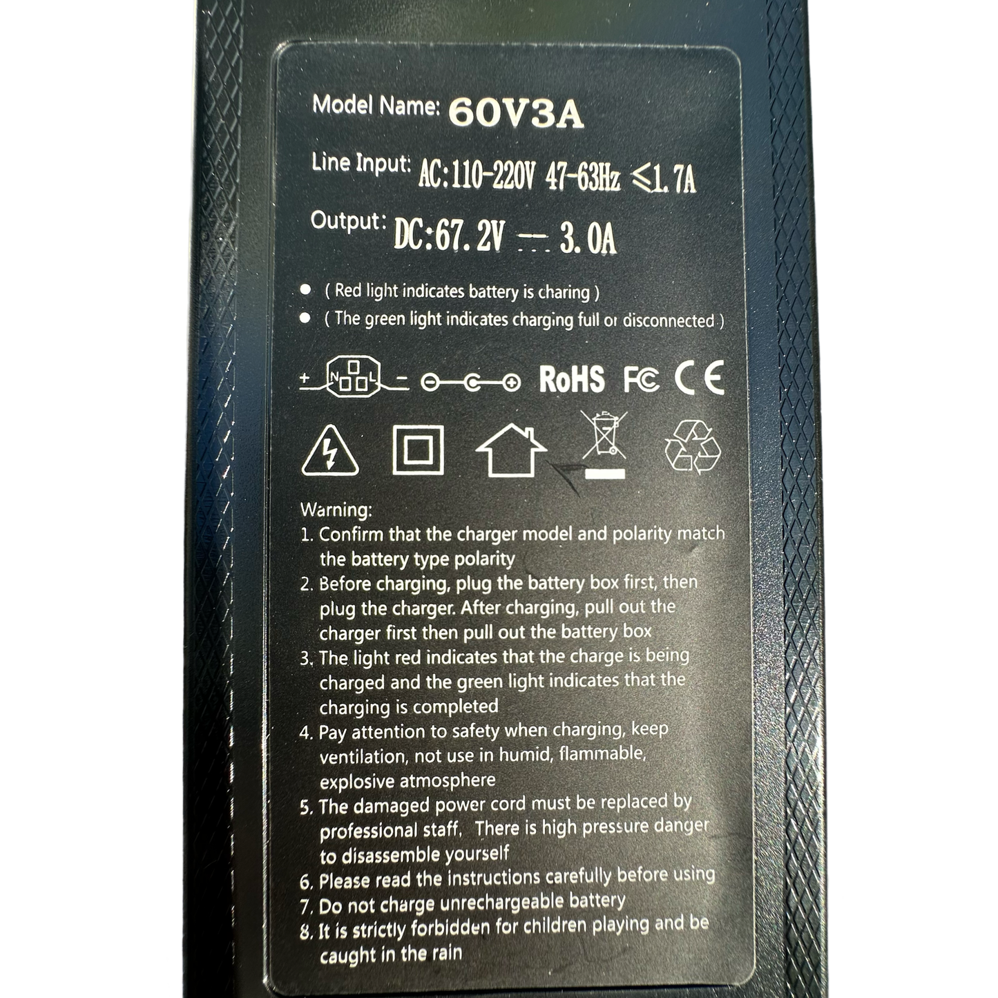Close-up of ElectricAllWheel 60V 3A E-Bike Battery Charger label showing model details, 110V input/67.2V output, Reention Mini 3-Pin to DC Adapter info, indicator lights, safety certifications, and warnings.