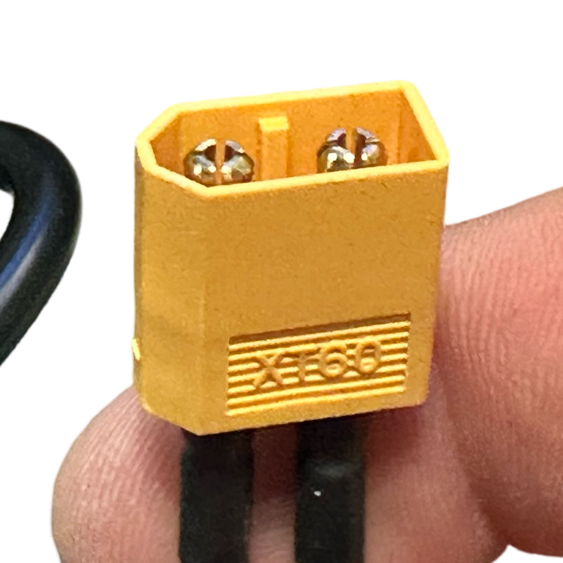 A close-up of a yellow XT60 connector held between fingers, with two black wires, commonly used for 48V brushless motors or when installing the ElectricAllWheel Replacement Controller (Throttle Unlocked) for Lectric XP3.0.