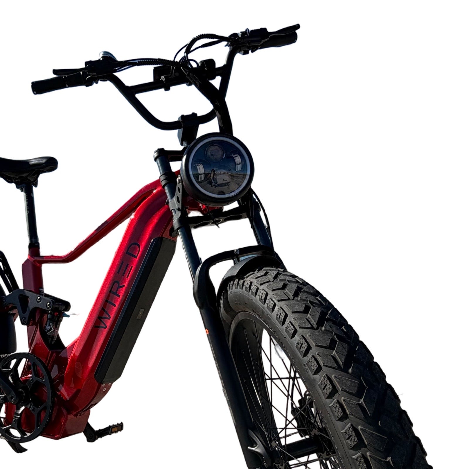 Red fat tire electric bike featuring an RST Guide dual crown fork (26”) and a motorcycle style LED headlight kit by ElectricAllWheel, "WIRED" branding visible on the frame, shown from a low front angle against a white background.
