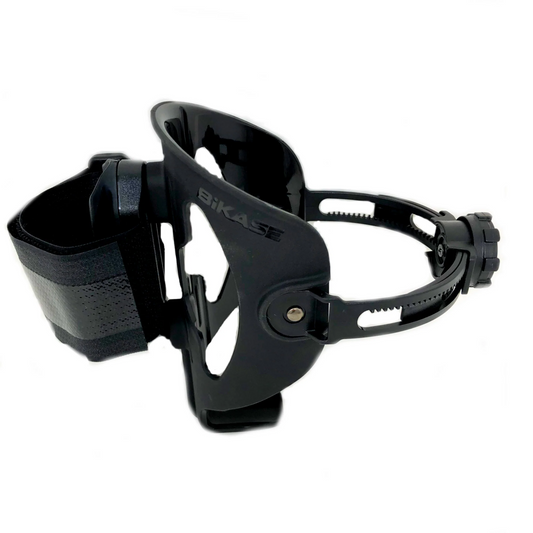 The Bikase Adjustable Drink Holder - BIKASE Anywhere, made of black plastic and featuring sturdy Velcro straps, provides universal compatibility for your bike accessories.