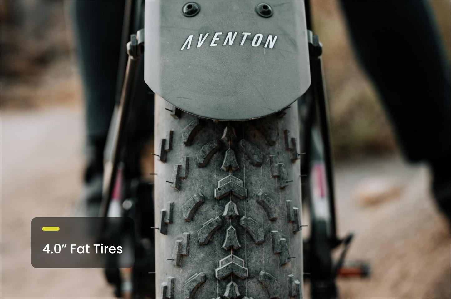 Close-up of a 4.0” fat tire on the Tampa Bay eBikes Aventon - Aventure M, showing tread details and high-torque performance. Text overlay reads "4.0” Fat Tires.