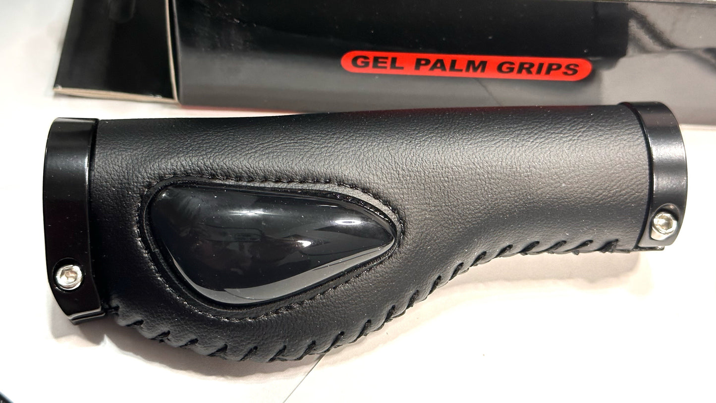 Close-up of the ergonomic grip from the ElectricAllWheel Thumb Throttle Conversion Kit (Lectric/AIPAS Fit), showing stitched edges, a glossy gel section, and packaging labeled with the kit name in the background.