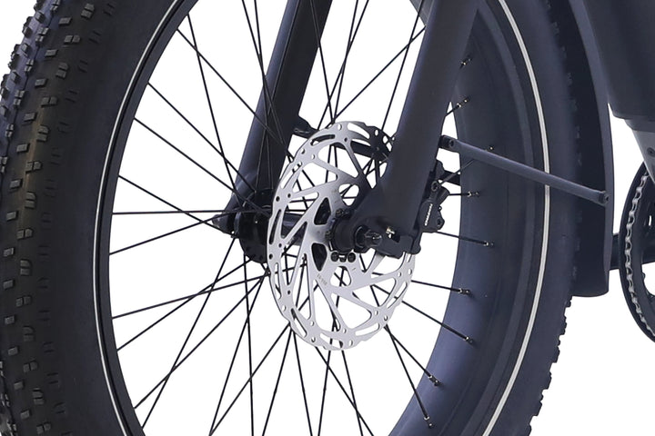 Close-up of the AIMA - Big Sur 2.0 fat tire bicycle's front wheel, featuring a disc brake rotor and black spokes by AIMA, set against a white background.