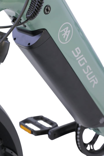 Close-up of the AIMA - Big Sur Sport 2.0 e-bike frame in green by AIMA, showing the battery compartment and a pedal.
