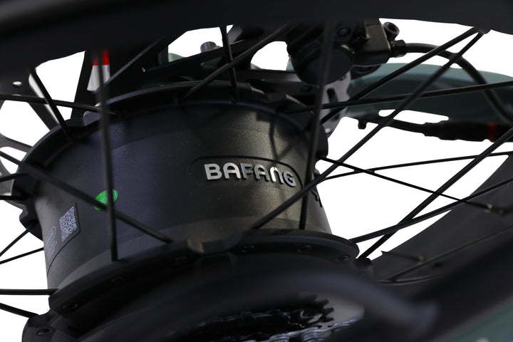 Close-up of an AIMA electric motor hub with black spokes on a fat tire, showcasing the all-terrain performance of the AIMA - Big Sur Sport 2.0.