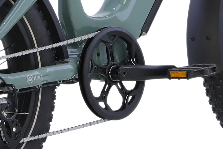 Close-up of the AIMA Big Sur Sport 2.0’s pedal, crankset, and chain on a green AIMA fat tire e-bike frame with black tires.