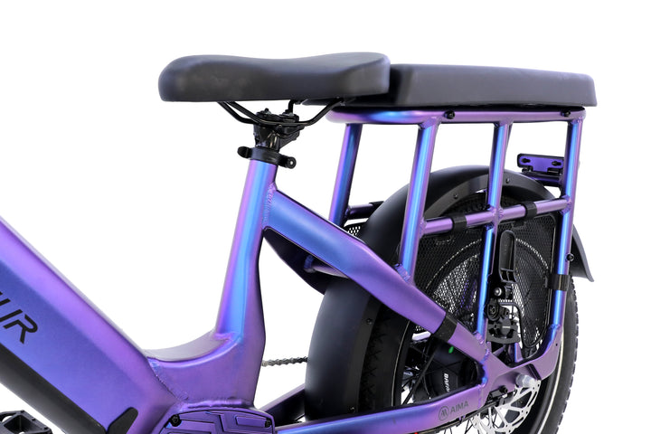 Close-up of the AIMA - Big Sur U Cargo by AIMA, showcasing its seat, frame, rear wheel, and cargo rack in purple against a white background.