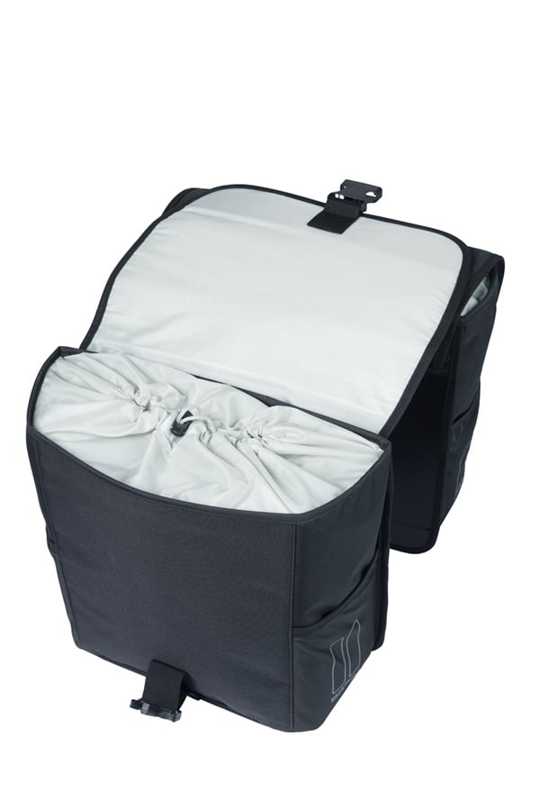 The Basil Go MIK Double Pannier Bag by Basil features black fabric, a light inner lining, two main compartments with drawstring closures, and a flap cover secured by buckles.