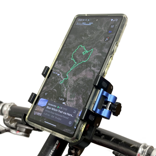 A smartphone held by the BiKASE Bikase BikGrip cell phone holder on a bike handlebar shows a trail map and route on its screen via a navigation app.