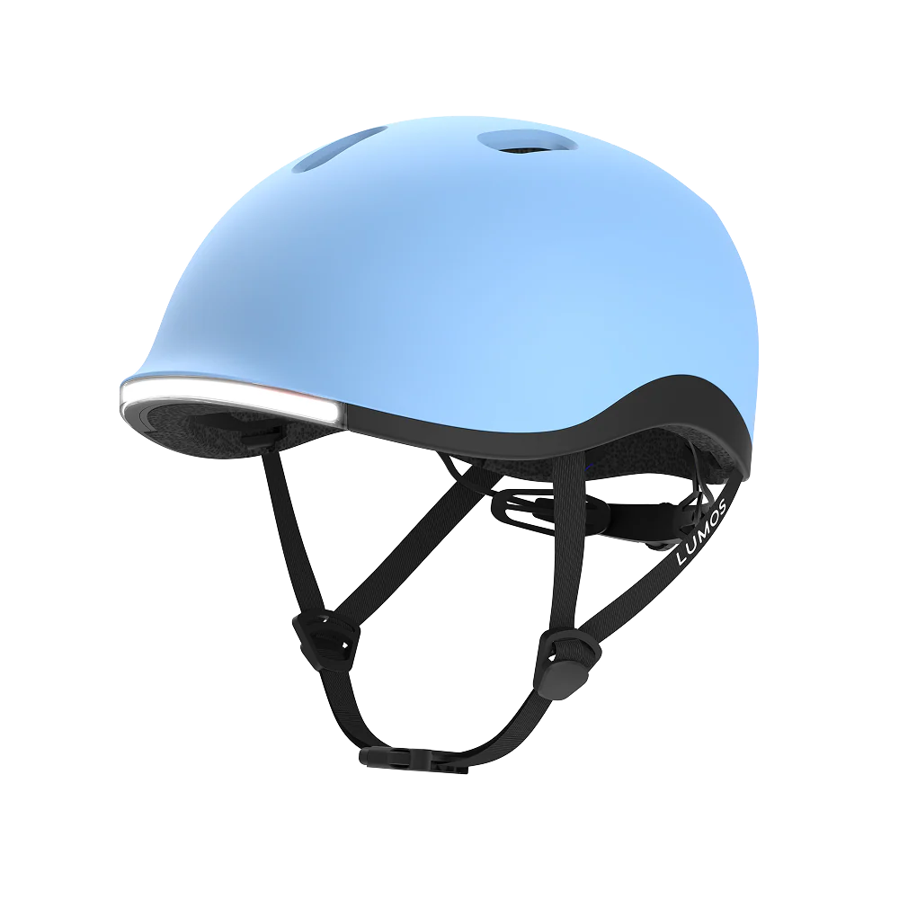 The Lumos NYXEL helmet features a light blue design, black adjustable straps, and a built-in front LED for greater visibility and safety on every ride.