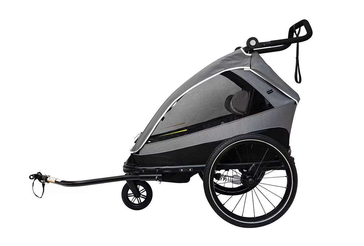 The Child Trailer - Aventon Double Seat by Aventon boasts a sleek gray design with two wheels, a black handle, and a transparent cover. It features comfortable seating and a foldable frame for easy storage and portability.