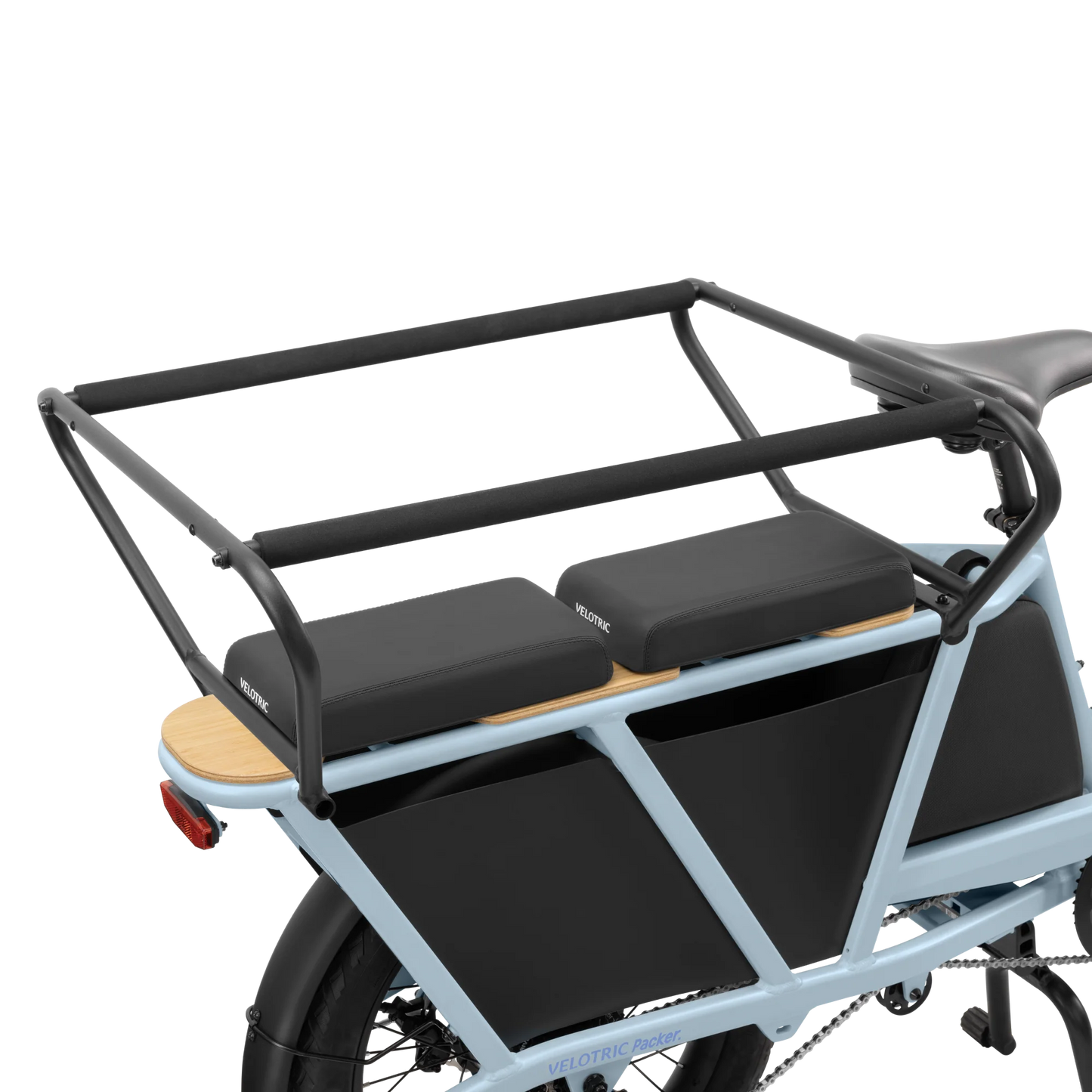 A Velotric Packer 1 blue cargo bike, known for its Child Safety Balustrade, features a black frame and is equipped with a robust rear rack for enhanced stability, plus a rear carrier with two padded seats.