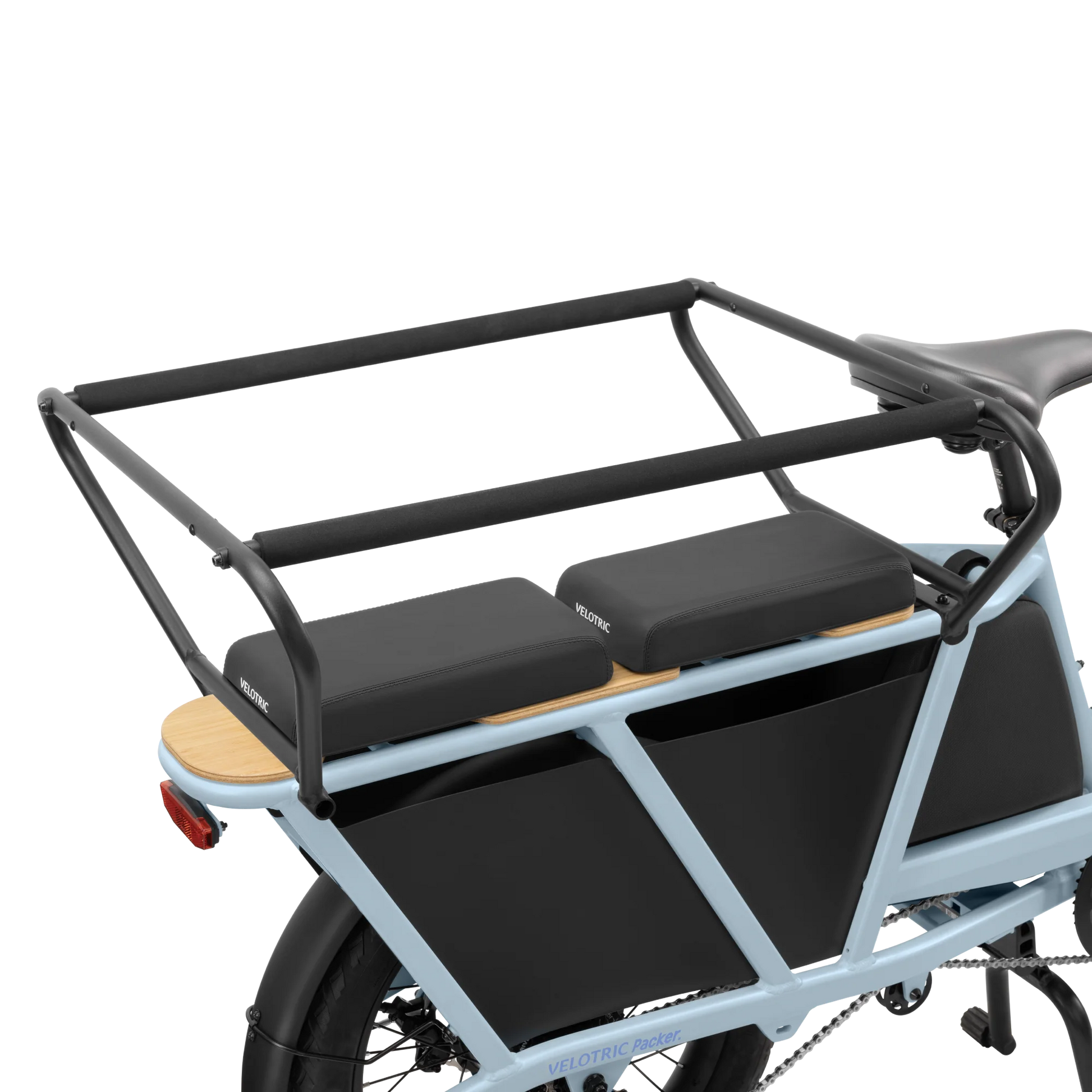 A Velotric Packer 1 blue cargo bike, known for its Child Safety Balustrade, features a black frame and is equipped with a robust rear rack for enhanced stability, plus a rear carrier with two padded seats.