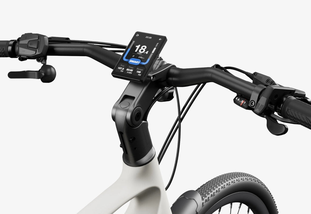 Close-up of the Urtopia - Carbon Classic handlebar by Urtopia, showing its digital display with speed, battery, and mode, plus brake levers and gear shifters on this lightweight eBike.