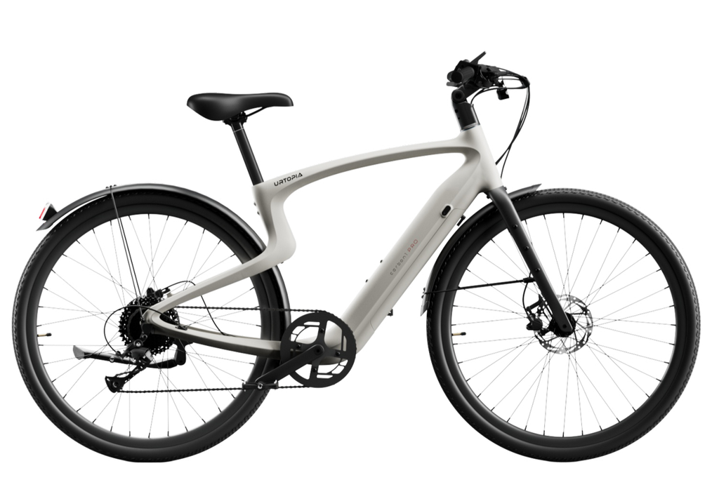 The Urtopia - Carbon Classic by Urtopia is a modern white eBike featuring a sleek carbon fiber frame, black seat, handlebars, and tires, shown in a side view against a plain background.