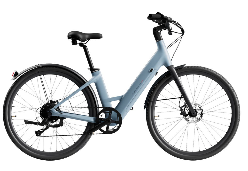 The Urtopia Carbon Classic Step-Thru eBike by Urtopia, shown from the side on a white background, features a light blue carbon frame, step-through design, removable Samsung battery, front suspension fork, disc brakes, and rear fender.