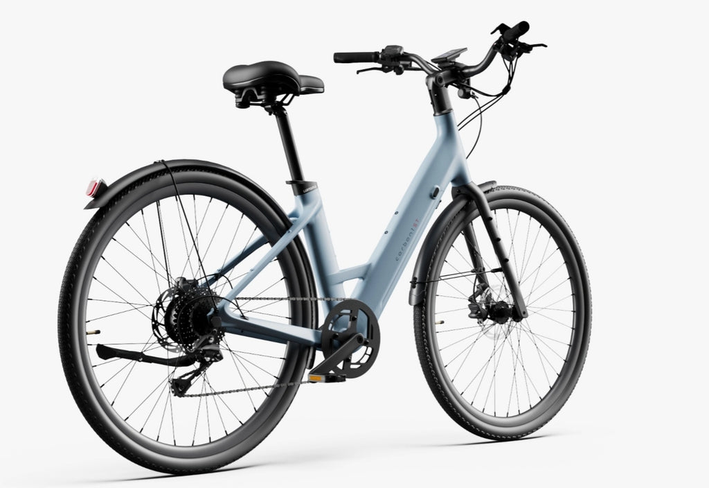 The Urtopia - Carbon Classic Step-Thru eBike by Urtopia features a light blue carbon frame, step-through design, black saddle and handlebars, front and rear fenders, removable Samsung battery, and rear red reflector against a white background.