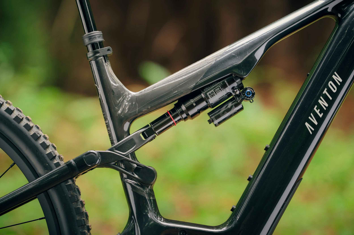 Close-up of the Aventon Current EXP's rear suspension and frame, showcasing the shock absorber and rear tire of this Aventon electric mountain bike.