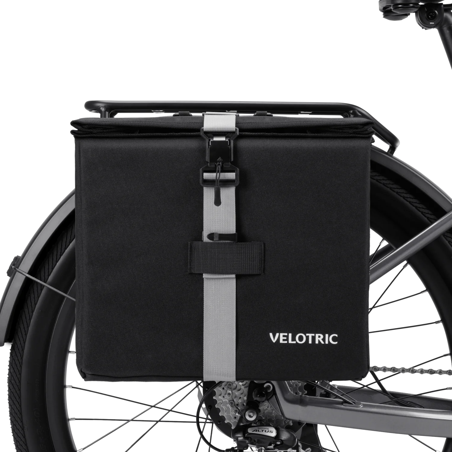 The Velotric - Rear Rack Pannier Bag by Velotric, in black with a gray front strap and buckle, is mounted on your eBike’s rear rack, providing waterproof utility for your rides.