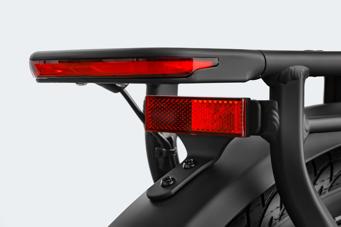 Close-up of red taillights mounted on the rear of a black Himiway A7 Pro bicycle frame, set against a plain white background.