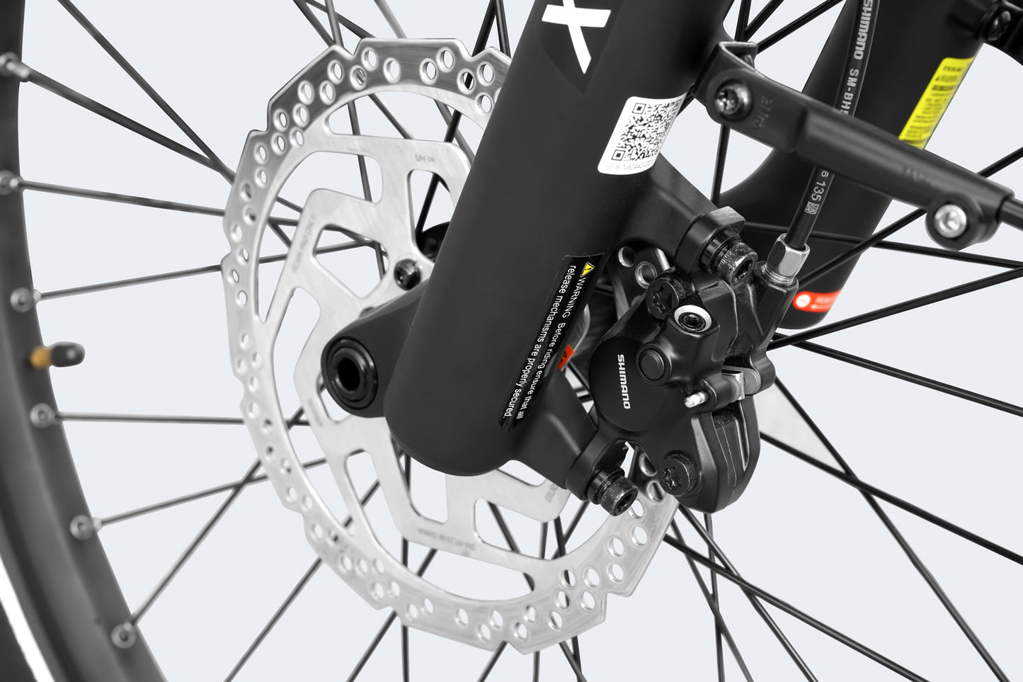 Close-up of a bicycle disc brake and wheel hub on a Himiway A7 Pro, showing detailed view of the brake caliper and rotor on a gray background.