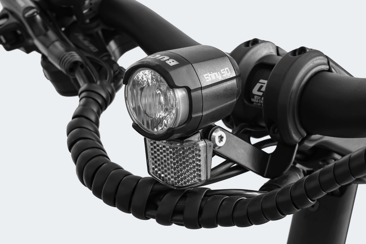 Close-up of a Himiway A7 Pro bicycle handlebar with an attached LED headlight and a small reflector, isolated on a white background.