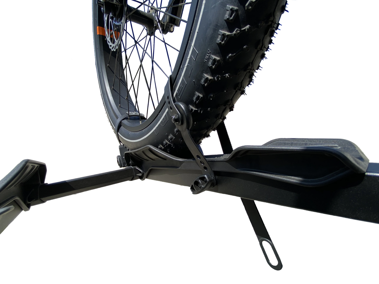 Close-up of a bicycle tire secured on a car bike rack with Hollywood Racks Extension Straps against a white background.