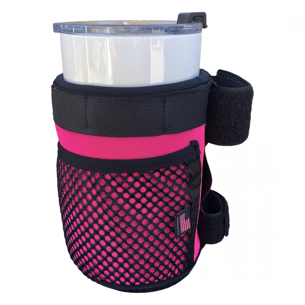 The Color Splash Drink Holder by Color Splash is a pink and black mesh bike cup holder with an insulated design, clear plastic cup inside, American flag tag, and adjustable strap.