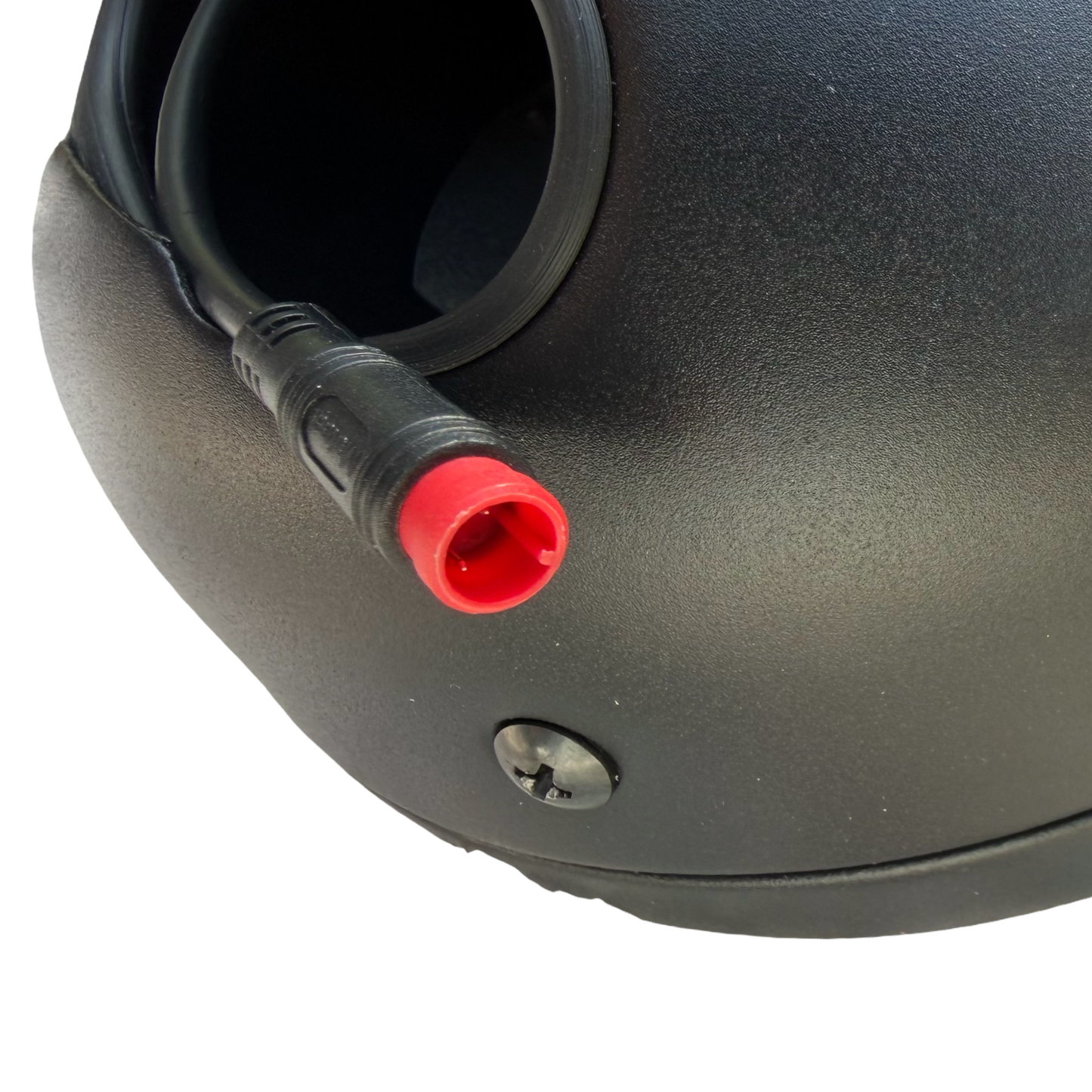 Close-up of the ElectricAllWheel RST Guide Dual Crown Fork (26" Fat Tire) & Motorcycle Style LED Headlight Kit (12V, 2-pin Julet) showing a black device with a red-tipped connector and screw, ideal for e-bike upgrades.