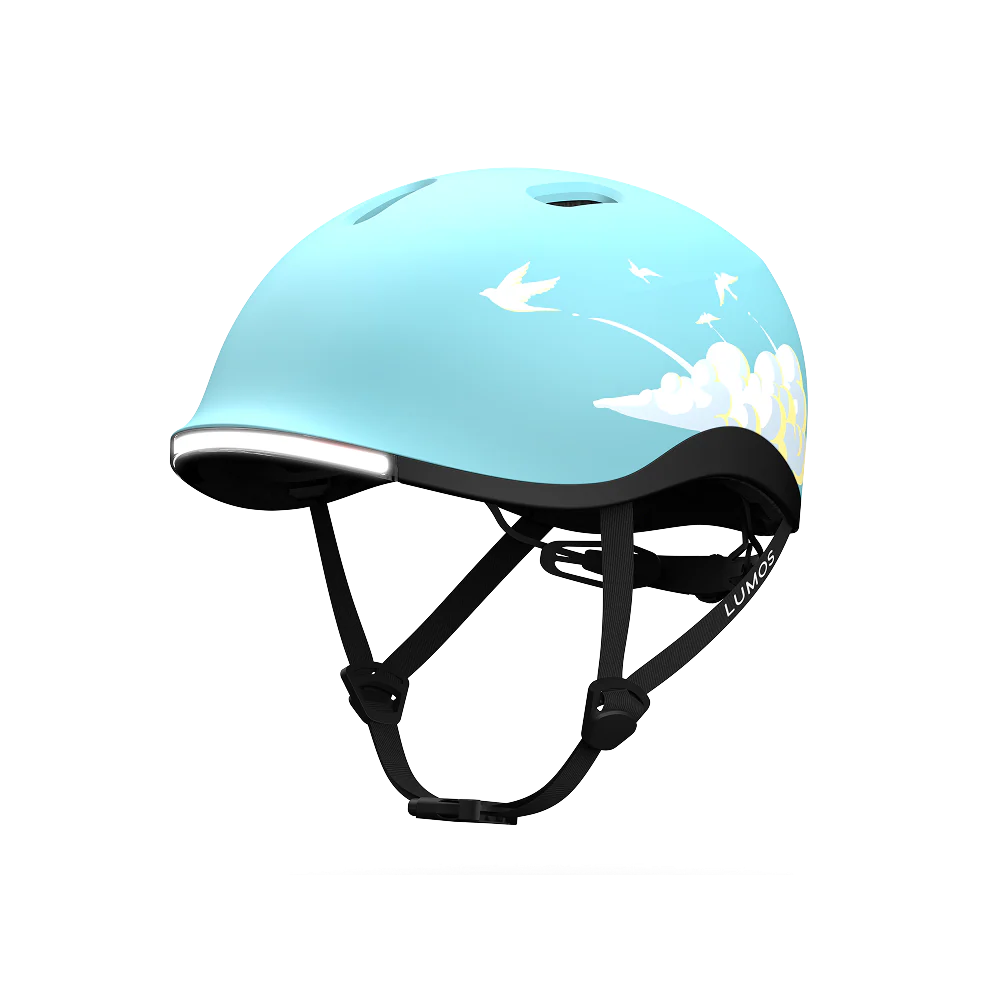 The Lumos NYXEL helmet features a light blue color with a white bird and cloud design, black adjustable straps, and top ventilation holes.